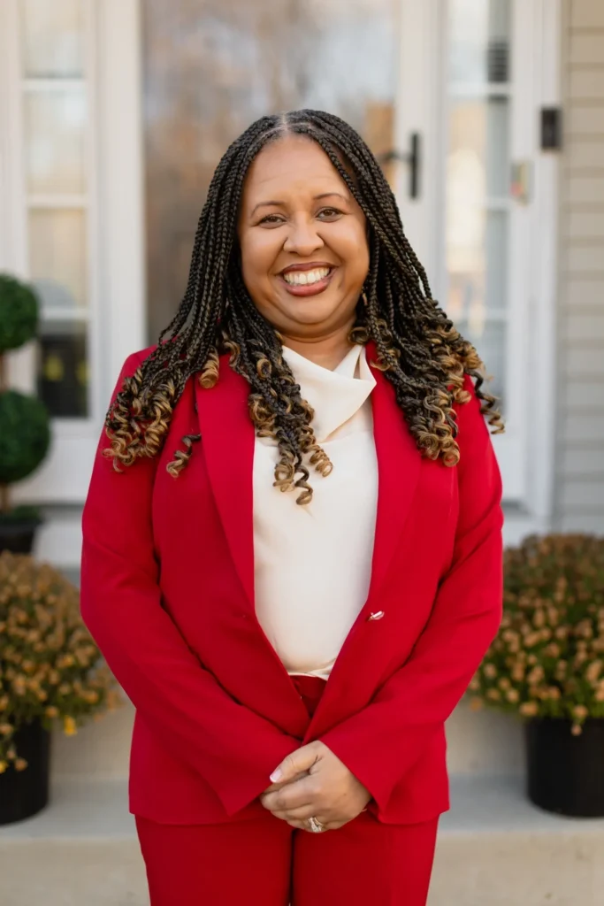 Smiling person in a red suit.