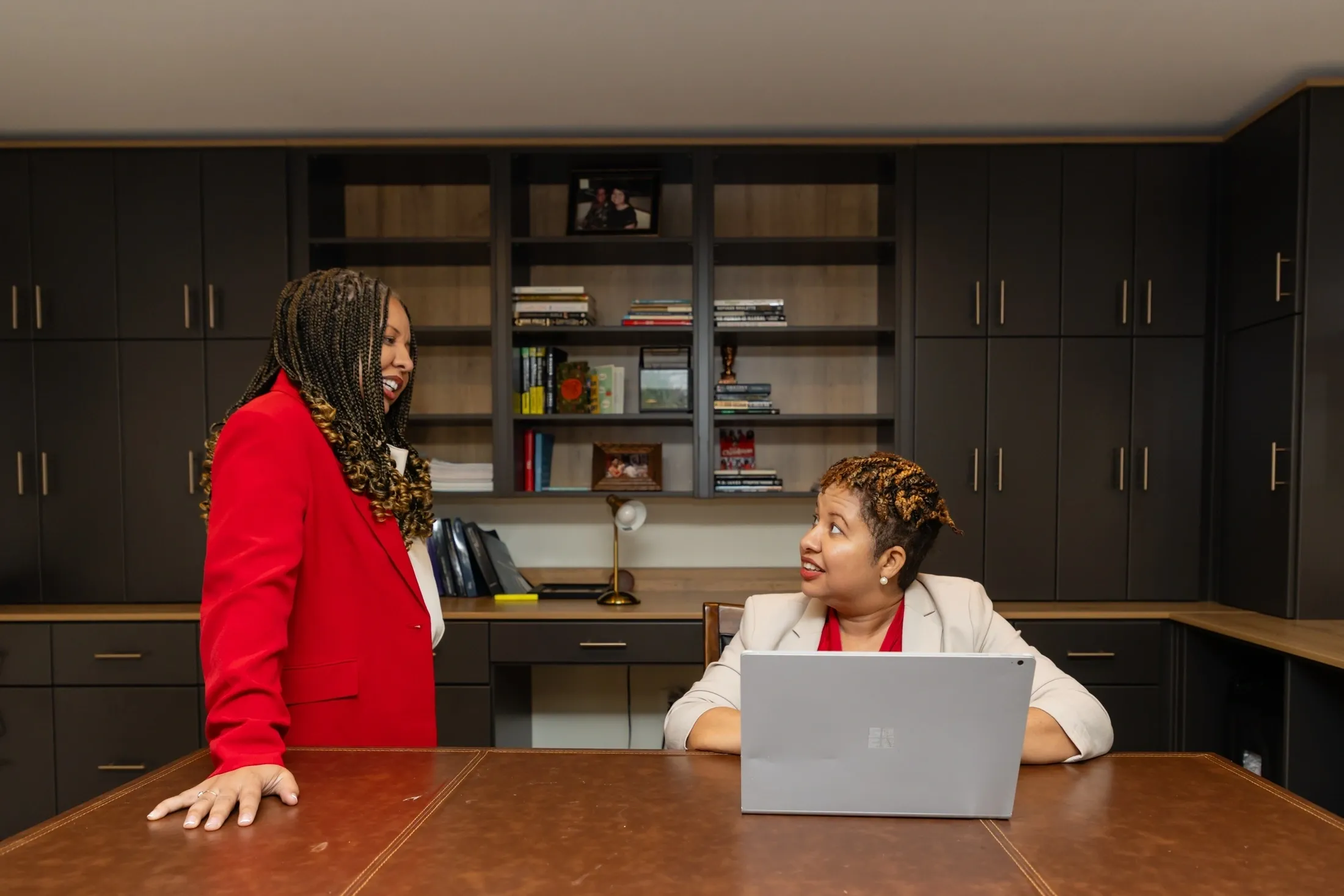 Two women talking in an office.